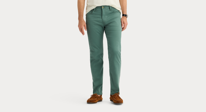 View of model wearing Duck Green Jean Cut Pants, Straight Fit.
