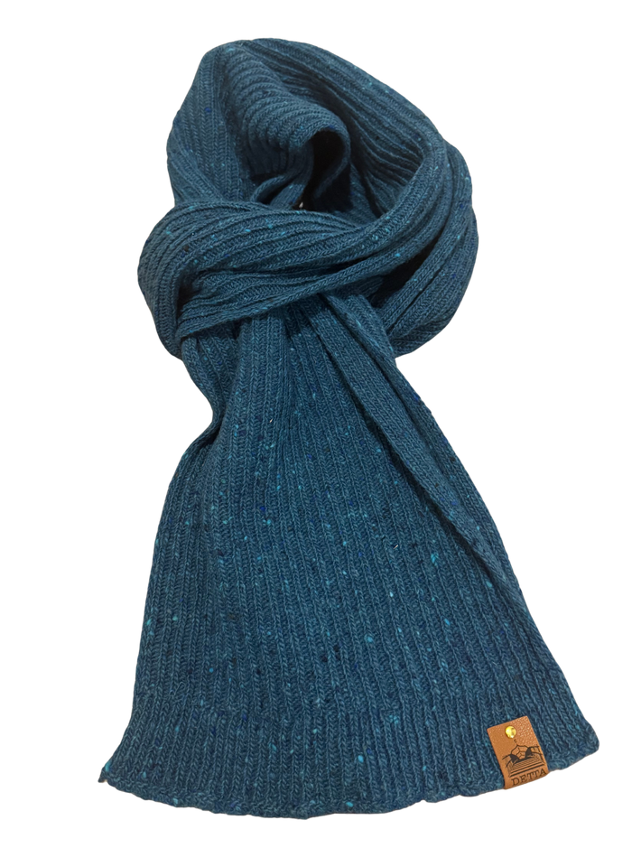 Blue knitted scarf with a brand tag on a white background