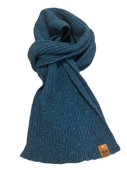 Blue knitted scarf with a brand tag on a white background