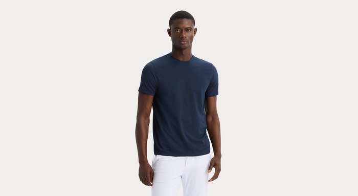 Front view of model wearing Navy Blazer Go Tee, Slim Fit.