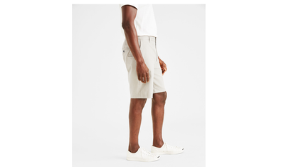 Side view of model wearing Porcelain Khaki Perfect 8" Shorts, Classic Fit.